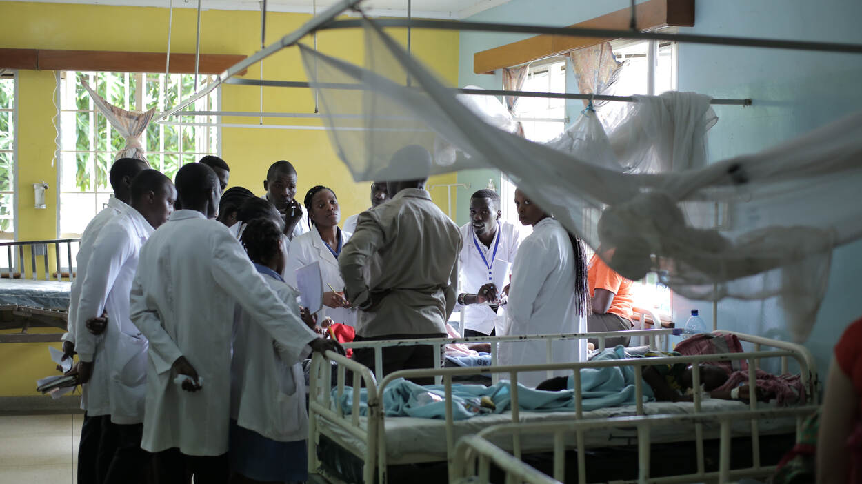 Doctors standing around a patient in Kenya