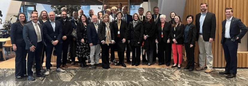 An image of the 25 person delegation visting from North Carolina standing in a group and smiling